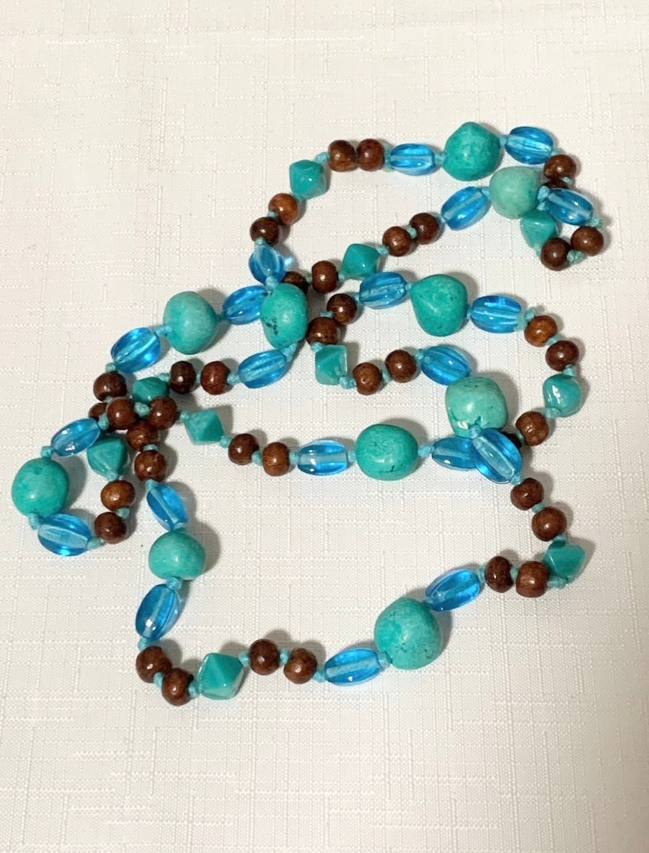 Long turquoise, wood, and Ceramic Beaded Necklace